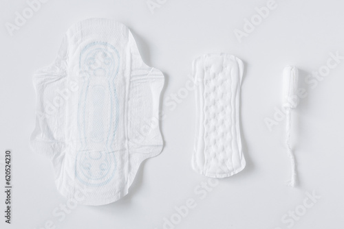 Set of different sanitary pads and tampon on white