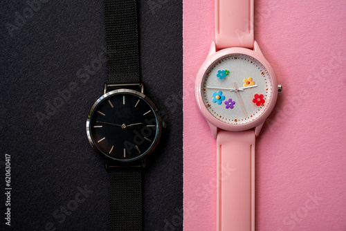 modern hand watches on black pink background, top view, flat lay of product, creative time expression 