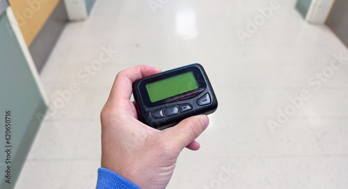 pager beeper lies on a desk, symbolizing instant communication and connection, bridging distances and enabling efficient messaging in the digital age