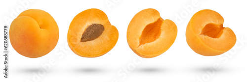 Pitted apricot slices on a white isolated background. Apricot slices with pits on different sides to insert into a design or project. Isolate of halves and whole apricots.
