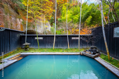 Kumamoto, Japan - Nov 22 2022: An open-air public bath surrounded by natural environment at Kurokawa Onsen, one of Japan's most attractive hot spring towns.