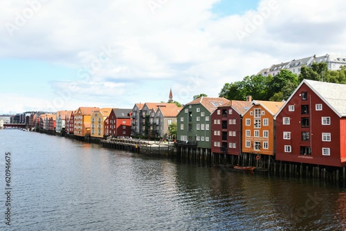 Colorful buildings line the canal running through Trondheim, Norway