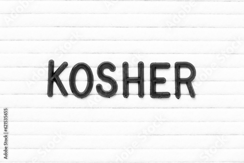 Black color letter in word kosher on white felt board background