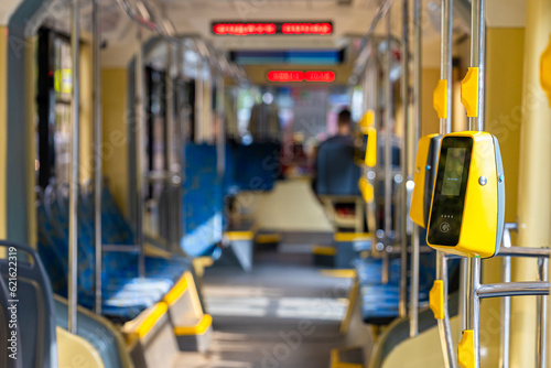 yellow validator in an empty tram car