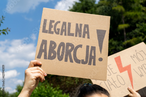 Female protester with placard sign supporting abortion rights in Poland. Women's Strike protest rally demonstration after death of young pregnant woman. Legalna aborcja, means legal abortion.
