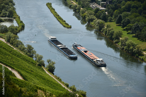 Bird's eye view of two barges on the Moselle loop surrounded by greenery and vineyards in Germany