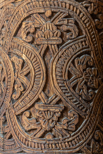 Floral ornament. Carving on wooden column in the Juma Mosque. Close up fragment, vertical, selected focus. Khiva (Xiva), Uzbekistan