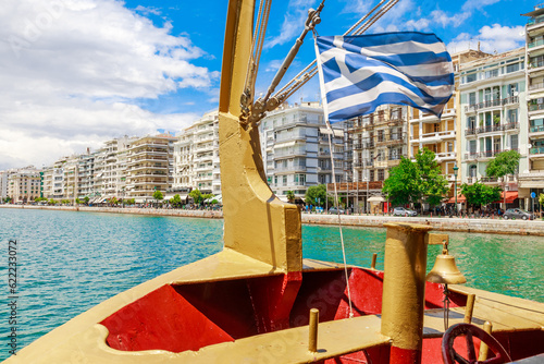 Thessaloniki promenade from ship, Greek flag. Greece, Macedonia, Europe.