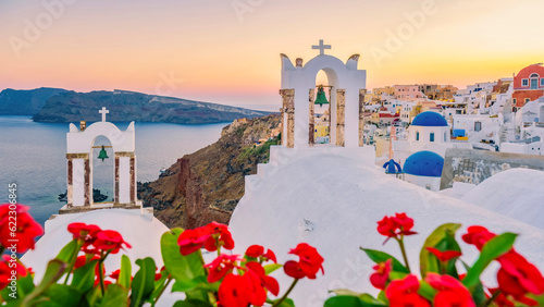 Sunset at the Island Of Santorini Greece, beautiful whitewashed village Oia with the church during sunset, streets of Oia Santorini during summer vacation at the Greek Island
