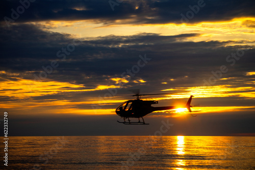 sunset on the beach with helicopter