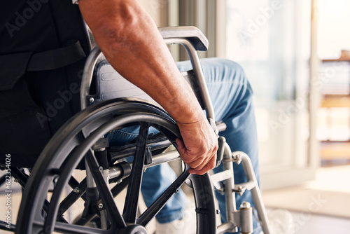 Man, hands and wheelchair for support, hope or travel in healthcare or medicare at home. Closeup of male or person with a disability moving on chair for mobility, surgery or wellness in the house