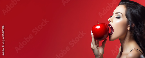 Beautiful young woman holding a red apple - symbolic of sin and temptation banner