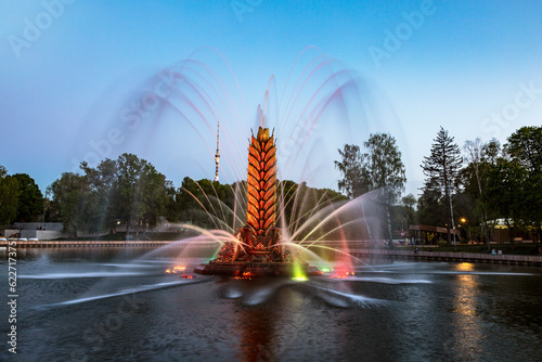 Fountain "Zolotoy Kolos" ("Golden spike") on the territory of the exhibition of achievements of the national economy, (VDNH) in the evening. Moscow, Russia