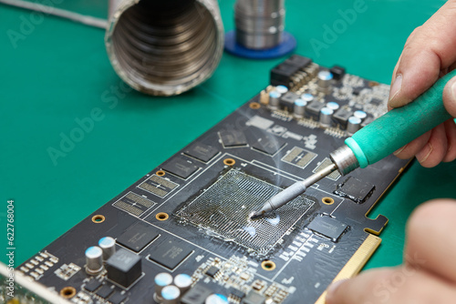 Cleaning the contact group of the video card for soldering the GPU chip. Soldering iron C245. Maintenance and repair of computer equipment.