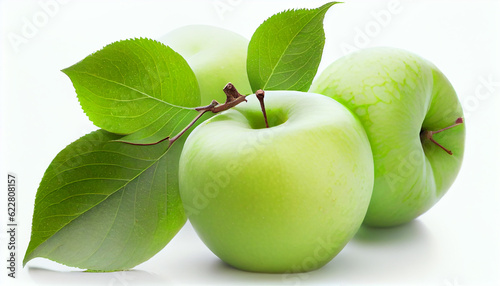 Green granny smith apples hang on branch with green leaves isolated on white background.