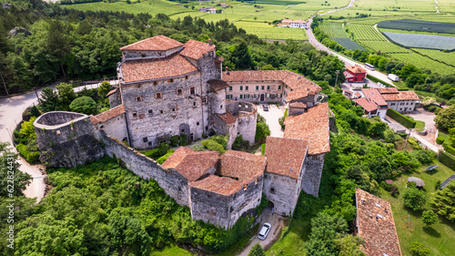 Castel Pietra surrounded by vineyards, aerial drone view - charming medieval castles of Italy in Trento province, Trentino region