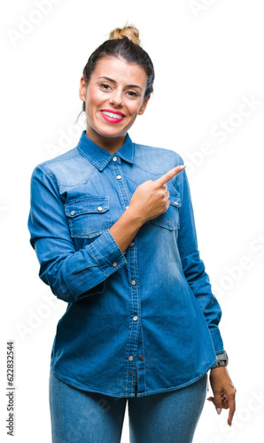 Young beautiful woman over isolated background cheerful with a smile of face pointing with hand and finger up to the side with happy and natural expression on face looking at the camera.
