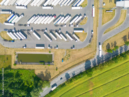 Aerial view of storage and freight terminal with trucks and cont