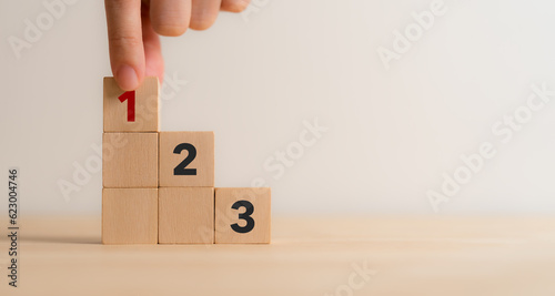 Task priority and management concept. The order of priority in any activity. Set work priority, arrange to do list. Wooden cube blocks with number first, second and third.