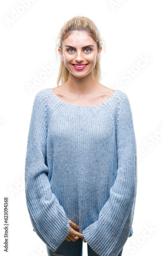 Young beautiful blonde and blue eyes woman wearing winter sweater over isolated background with a happy and cool smile on face. Lucky person.