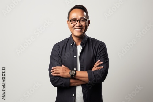 Portrait of happy asian man in eyeglasses smiling at camera