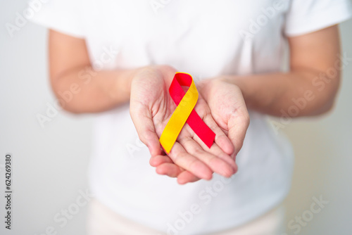 woman holding Red and Yellow ribbon. World hepatitis day awareness month, 28 July, Liver cancer, Jaundice, Cirrhosis, Failure, Enlarged, Hepatic Encephalopathy and Health concept