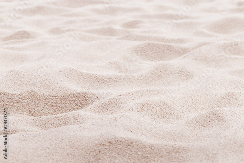 Beige pink Sand texture natural background. Close up waves pattern on sand dunes, light pastel color, minimal nature beautiful beach. Summer and travel, spa and relaxation concept. Selective focus.