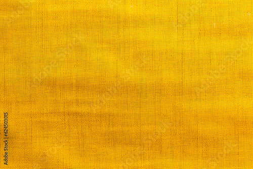 yellow fabric texture with subtle horizontal lines and variations close up
