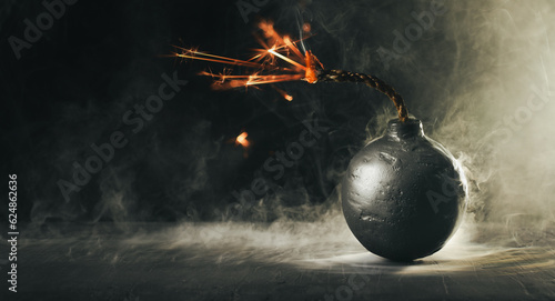 Round black bomb with lit fuse burning and sparking surrounded by smoke. Bomb about to detonate symbolizing destruction, threats, or dangerous violence.