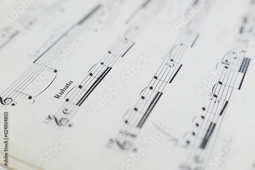 close up of musical notation and musical notes on a sheet of paper