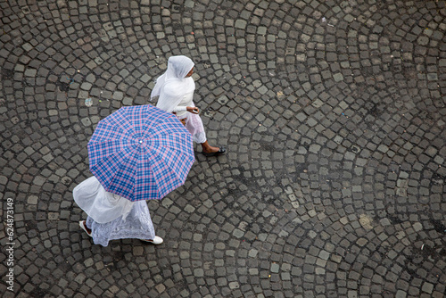 High angle view of two women walking on a cobblestone street in Addis Ababa, Ethiopia