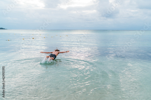 Diving teenage boy snorkeling underwater in the lagoon on Le Morne beach, Indian Ocean, Mauritius island. Exotic traveling and vacation concept