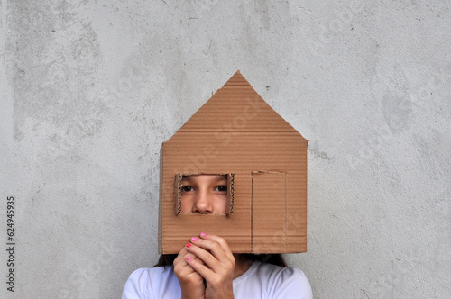 criança brincando com casinha de papelão, sonho da casa própria, negócios imobiliários, casa em contrução e financiamento da casa própria