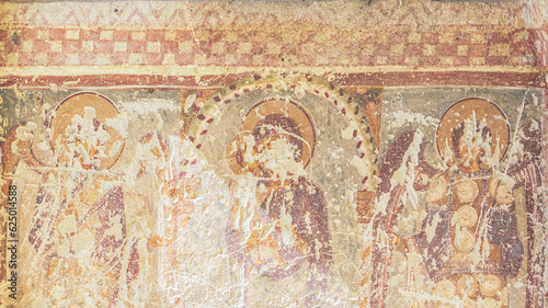 Fresco of Virgin Our Lady and archangels. Partially destroyed painting at the outer wall of Dark Church. Goreme Open air museum, Cappadocia, Turkey. Restoration and heritage preservation concept.