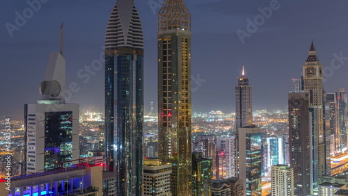 Skyline view of the high-rise buildings on Sheikh Zayed Road in Dubai aerial night to day timelapse, UAE.