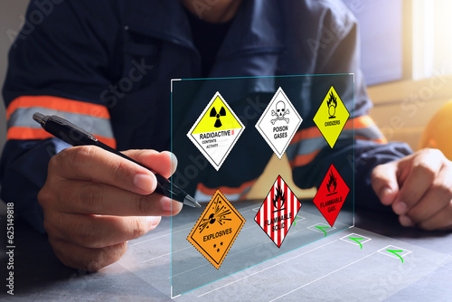 The warehouse safety officer inspects the check list of hazardous chemicals dangerous to meet safety standards before transport or distributed to industrial plants or export to foreign countries.