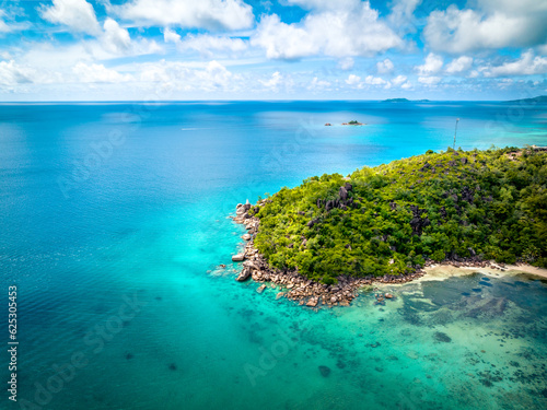Praslin Seychelles tropical island with withe beaches and palm trees. Aerial view of tropical paradise beach with white sand and turquoise crystal clear waters of Indian Ocean