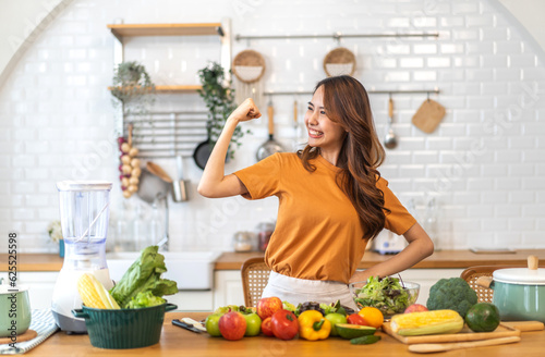 Portrait of beauty body slim healthy asian woman having fun cooking and preparing vegan food healthy eat with fresh vegetable salad, vegetarian on counter in kitchen at home.Diet.Fitness, healthy food