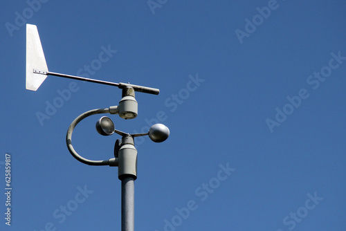 Weather station instruments against blue sky background