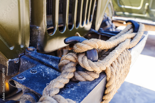Towing rope of a retro car. Emergency hook on the bumper of a vintage truck. Close up