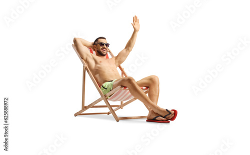 Guy in swimwear enjoying on a beach chair and waving