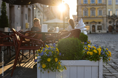 Young couple in outdoor cafe on Market square in Lviv, Ukraine