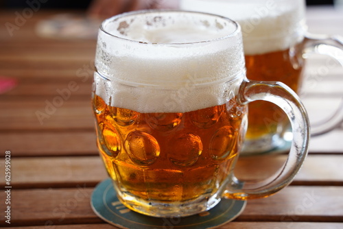 Czech-style Pilsner lager golden beer on table of bar pub restaurant in Prague, Czech Republic.