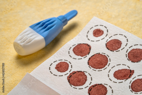 lancet and dry blood spots on a fiber filter for laboratory analysis, home health testing concept