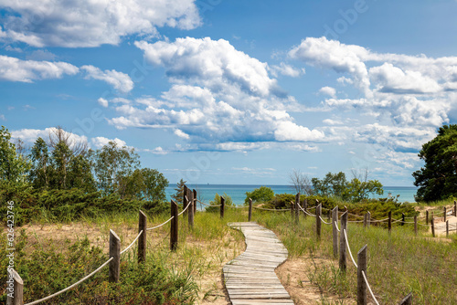Kohler Andrae State Park Sheboygan Wisconsin boardwalk through dunes with rope fence to blue Lake Michigan in summer