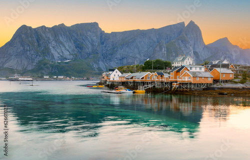 Beautiful view of scenic Lofoten Islands archipelago winter scenery with traditional yellow fisherman Rorbuer cabins in the historic village of Sakrisoy at sunrise, Norway, Scandinavia