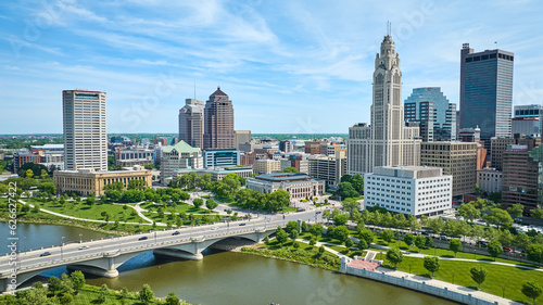 Skyscraper view of downtown Columbus Ohio with green part and driving bridge aerial