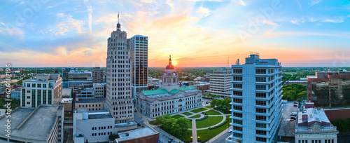 Panorama aerial downtown Fort Wayne golden morning sunrise breaking into brilliant blue skies