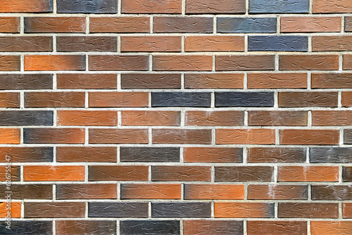 Texture of a black, orange and brown clinker brick wall as an architectural background