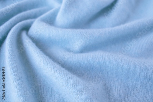 Blue cashmere fabric, textile is folded, knitwear texture, natural fabric, top view